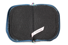 Load image into Gallery viewer, Interior view of jewelry/sewing case showing midnight blue lining and pockets, and black felt pages.