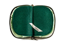 Load image into Gallery viewer, Interior view of jewelry/sewing case showing shimmery light green lining and pockets and dark green felt pages.