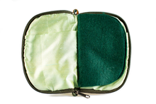 Load image into Gallery viewer, Interior view of jewelry/sewing case showing shimmery light green lining and pockets and dark green felt pages.