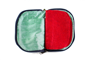 Interior view of jewelry/sewing case showing mermaid iridescent teal lining with pockets and red felt pages.