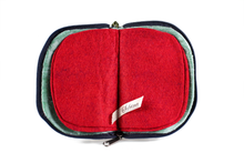 Load image into Gallery viewer, Interior view of jewelry/sewing case showing mermaid iridescent teal lining with pockets and red felt pages.
