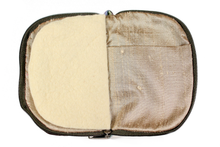Load image into Gallery viewer, Interior view of jewelry/sewing case showing a gold lining and pockets and cream colored felt pages.
