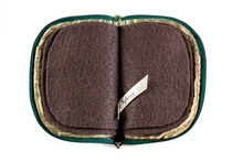 Load image into Gallery viewer, Interior view of jewelry/sewing case, showing dark gold lining and pockets, and dark brown pages.
