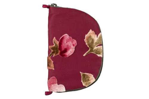 Front view of dark rose colored burnout velvet jewelry/sewing case showing velvet roses, a dark green zipper, and two small burgundy loops, one situated at the top and one at the bottom. 
