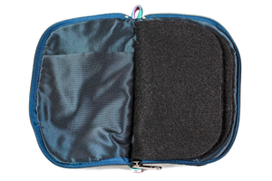Interior view of jewelry/sewing case showing midnight blue lining and pockets, and black felt pages.