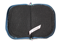 Load image into Gallery viewer, Interior view of jewelry/sewing case showing midnight blue lining and pockets, and black felt pages.
