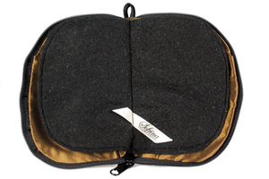 Interior view of jewelry/sewing case showing dark gold lining and pockets and black felt pages.