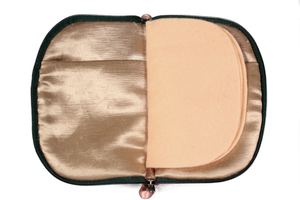 Interior view of jewelry/sewing case showing champagne colored lining and pockets and peach colored pages.