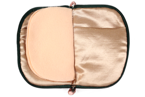 Front view of bright pink floral linen jewelry case with a dark green zipper and two small light pink loops, one situated at the top and one at the bottom.