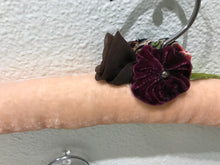 Load image into Gallery viewer, Close-up view of Blush Velvet Padded Hanger showing off the burgundy velvet flower and a brown flower.
